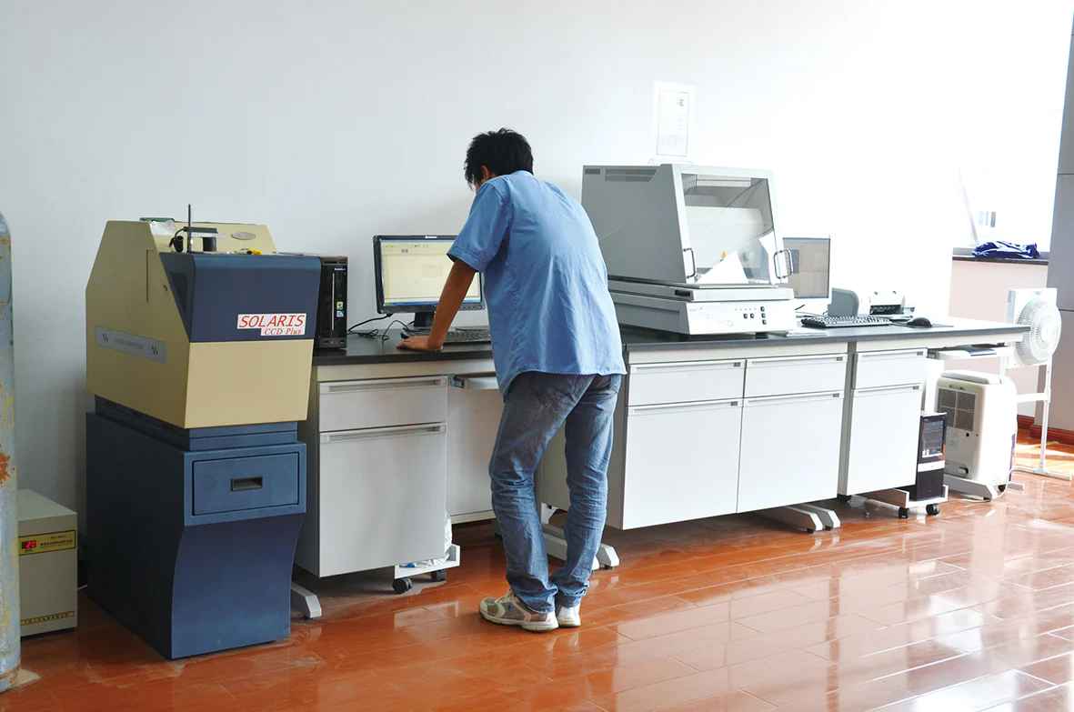 Technician using spectrometer equipment in the company laboratory
